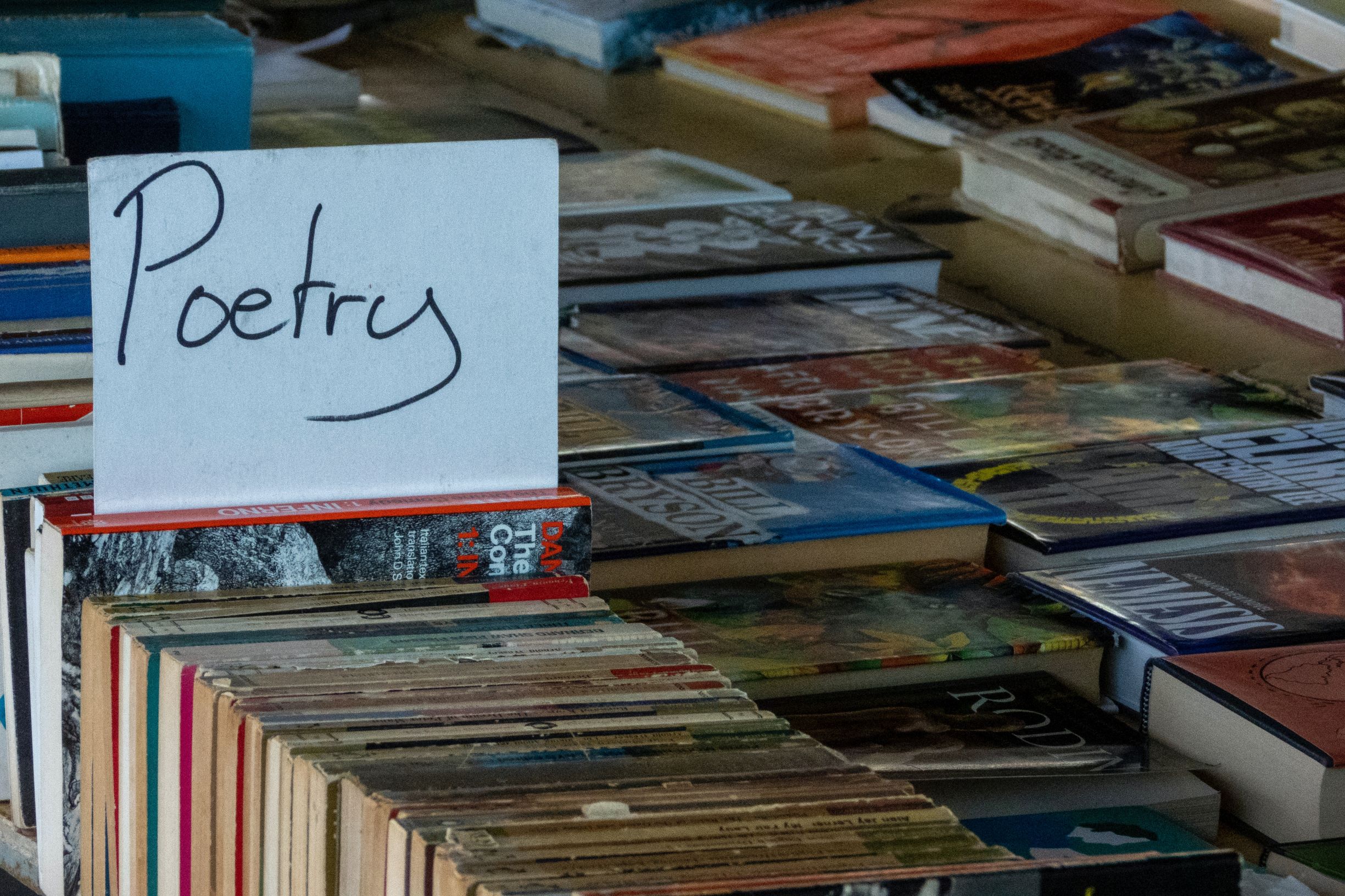 Image of a book stall with sign reading 'poetry'.